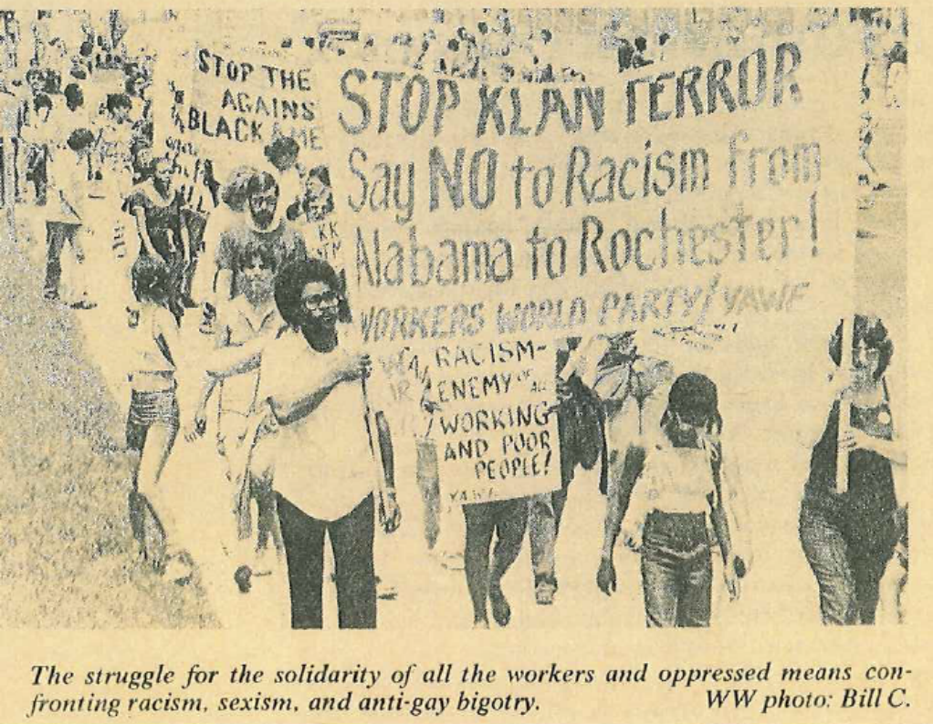 Image of protesters, one visible sign 'Stop Klan Terror Say NO to Racism from Alabama to Rochester! WORKERS WORLD PARTY' Caption 'The struggle for the solidarity of all the workers and oppressed means confronting racism, sexism, and anti-gay bigotry.'